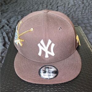 New Era Kids Brown Snapback Hat with White NY Logo and Gold Embroidery